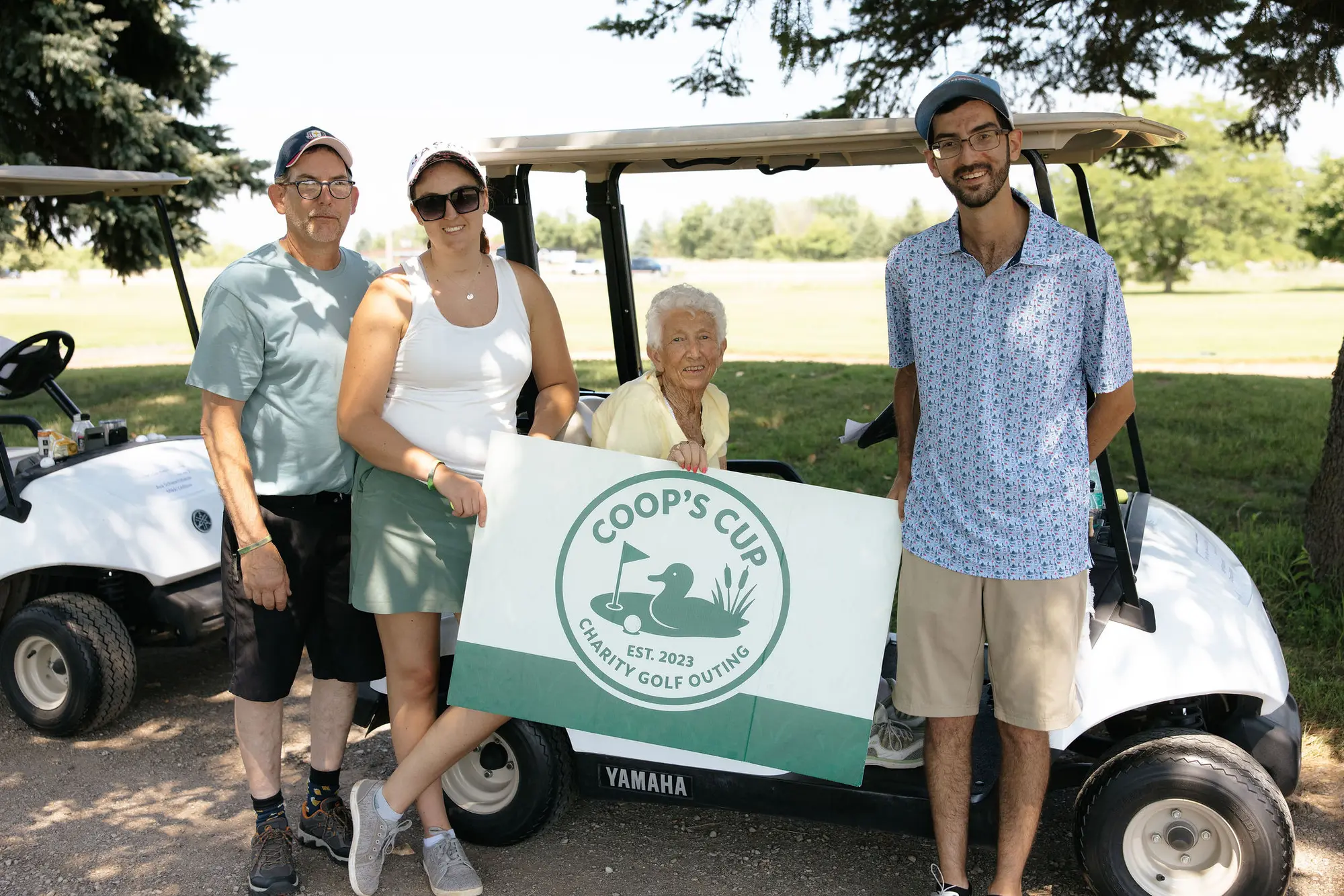 Friends gather beside a golf cart