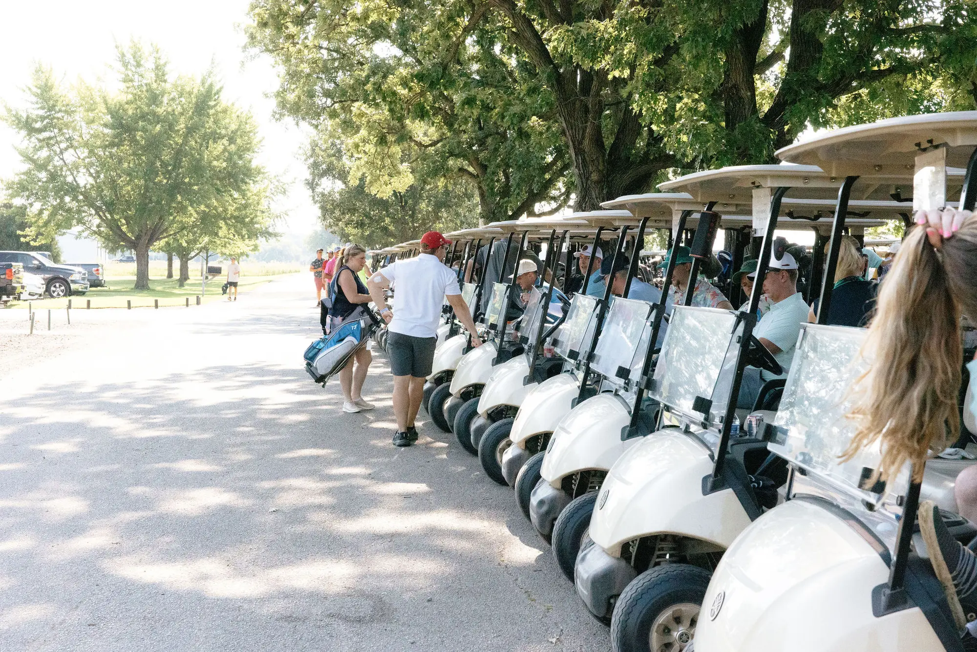 Golf carts lined up and ready for the outing