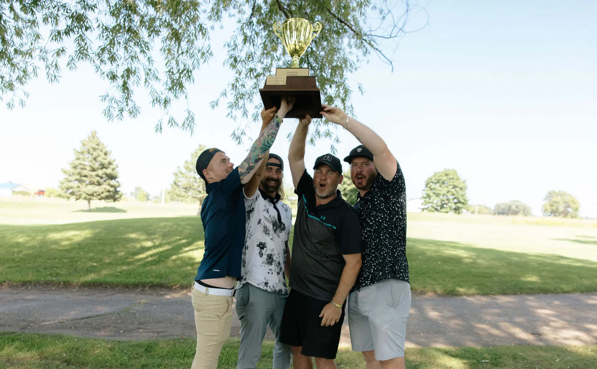The 2026 champions lifting the Coop's Cup trophy