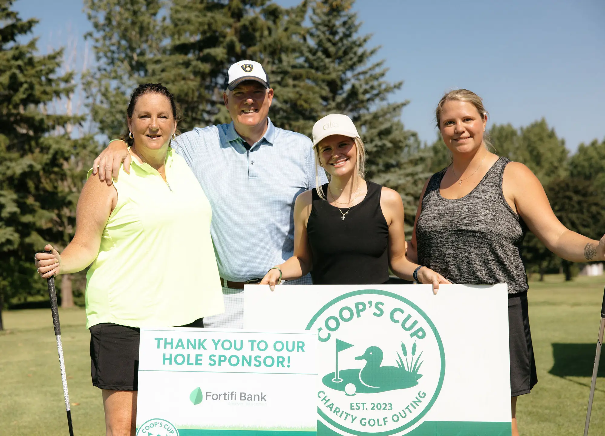 Golfers thank a 2026 hole sponsor