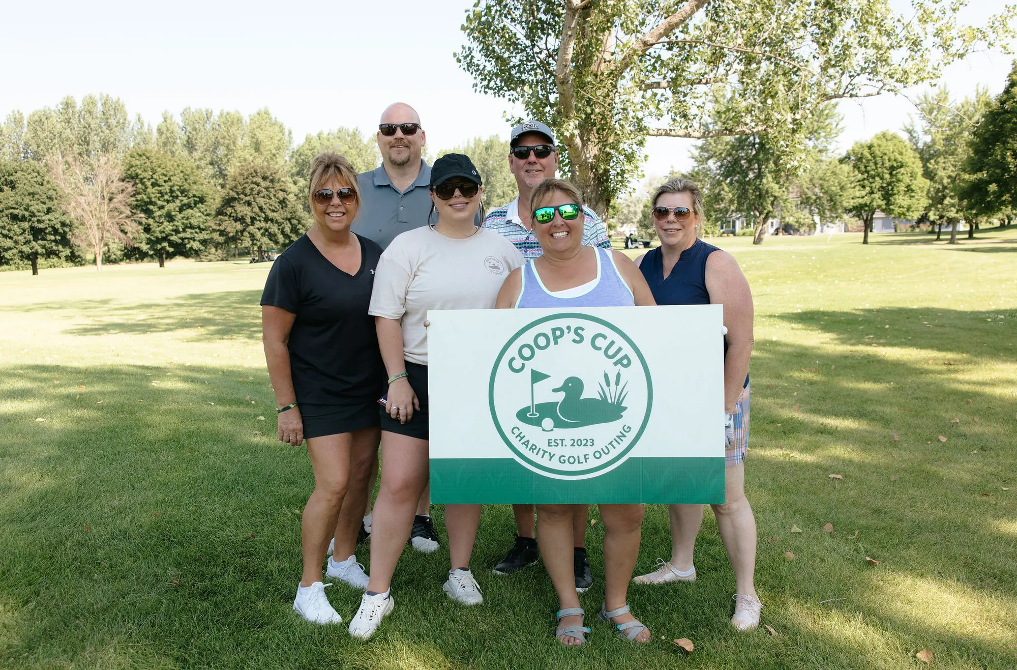 A foursome gathers on the course