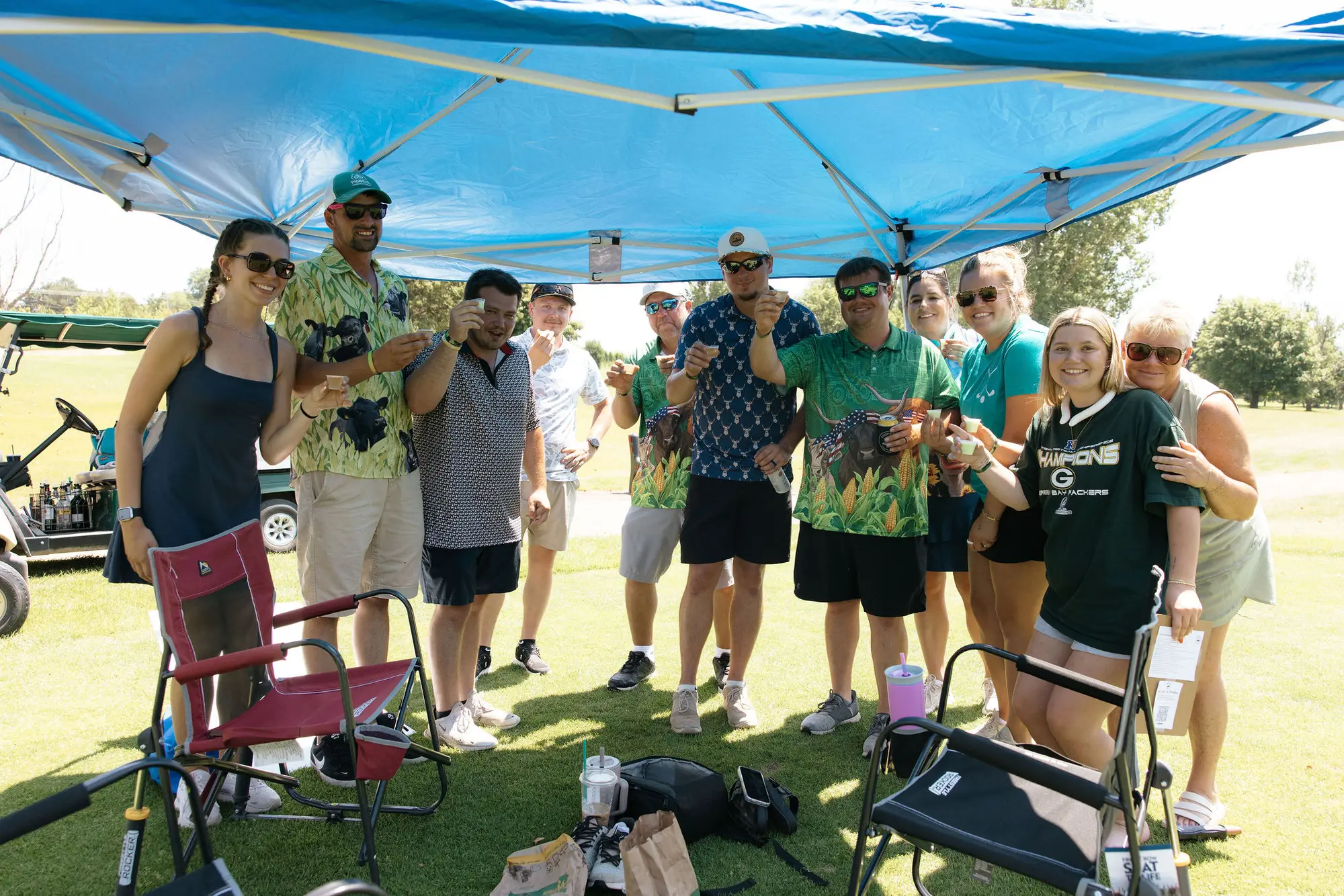 Volunteers and guests gathered under the Coop's Cup event tent