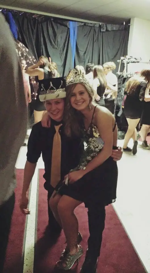 Dakota and Cassie smiling together while wearing crowns