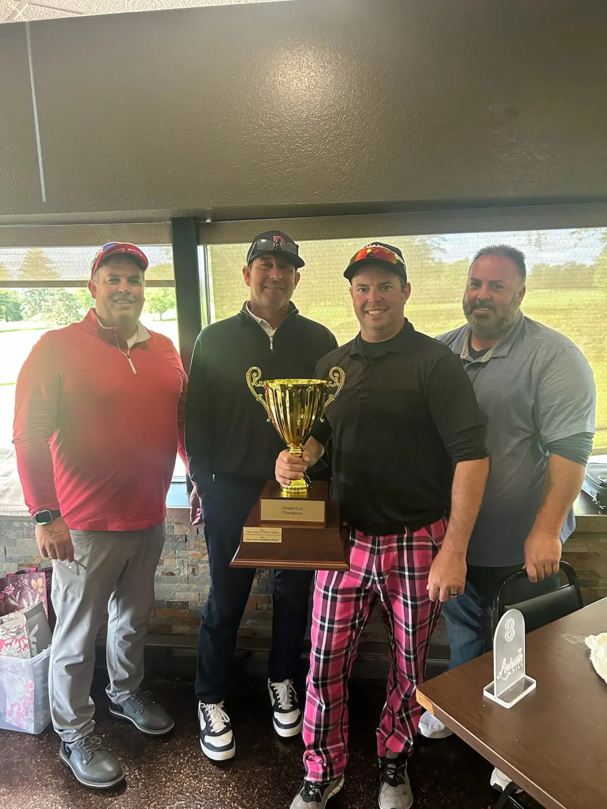 Jim White, Michael Wolverton, Eric Brandt, and Jamie Noble with the 2025 Coop's Cup trophy